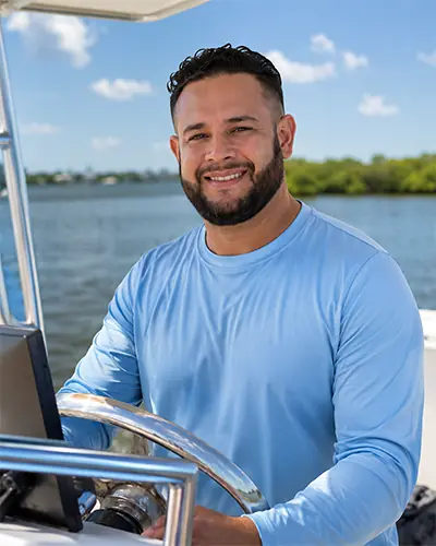 Captain Ede at the helm of an Englewood Boat Tours vessel