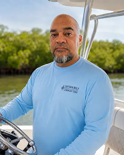Captain Roly at the helm of an Englewood Boat Tours vessel